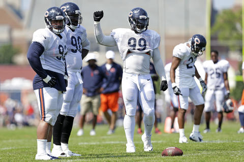 Bears defensive end Lamarr Houston (99) and the defense line up.
