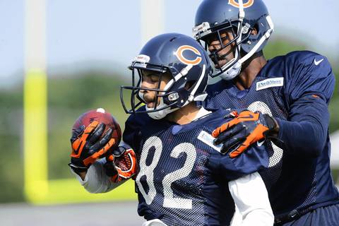 Bears wide receivers Chris Williams (82) and Josh Morgan work on holding on to the ball.