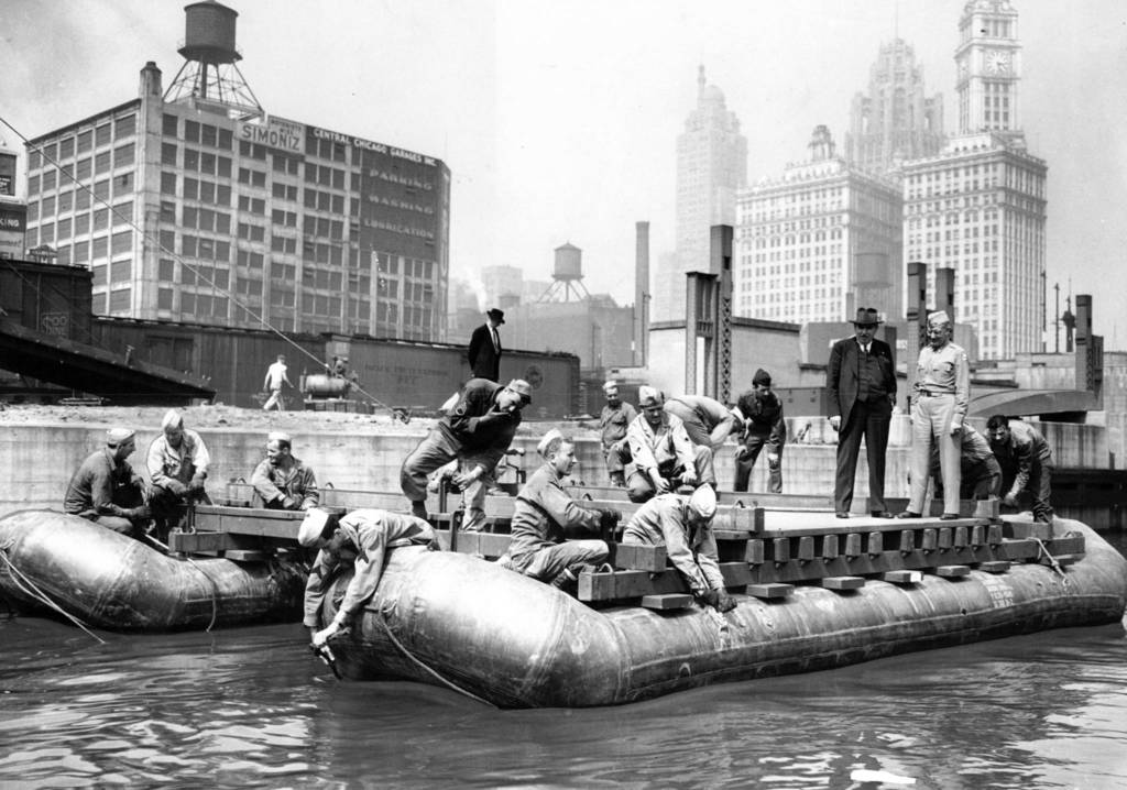 Army engineers build a pontoon bridge across the Chicago River at State Street as a demonstration of their work, circa June 13, 1945. The Tribune Tower is visible in the background.