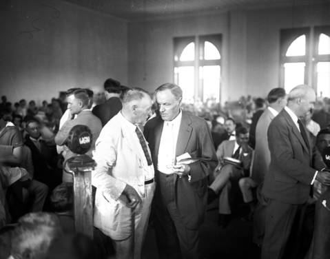Prosecutor Ben G. McKenzie, left, and Clarence Darrow, center, in July 1925.