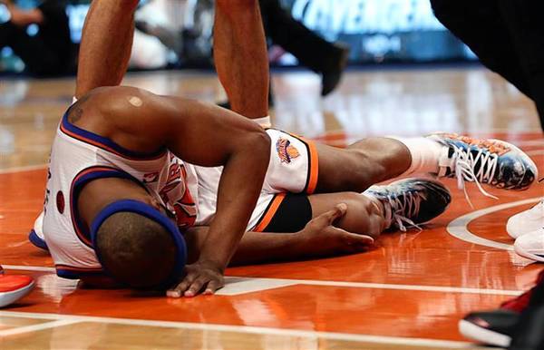 Knicks' Davis grabs his right knee after an injury in Game 4 of their NBA Eastern Conference basketball playoff series against the Heat in New York