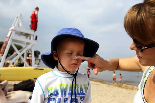  Kristin Conn, of Evanston, applies non-nano sunscreen to her son Merrick, 4, at Lee Street Beach in Evanston. Conn is a co-founder of MightyNest.com, an online natural products marketplace, which lists sunscreens that are mineral-based, broad-spectrum and free of nanoparticles.