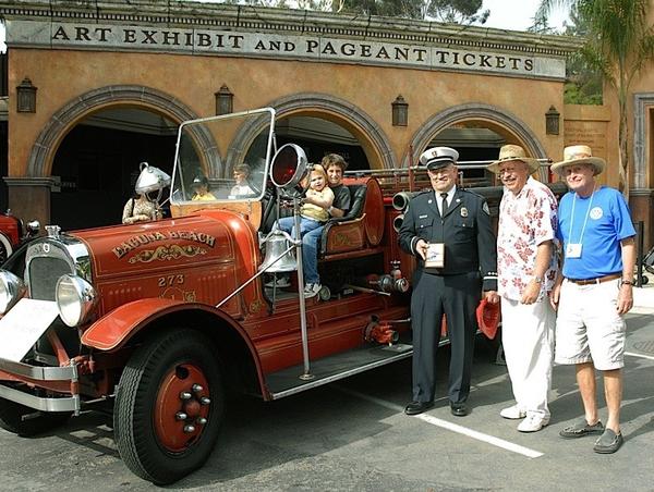 Attendees pose with an old fire car at the 2011 Laguna Beach Classic Car Show. The event will take place again Sunday. 