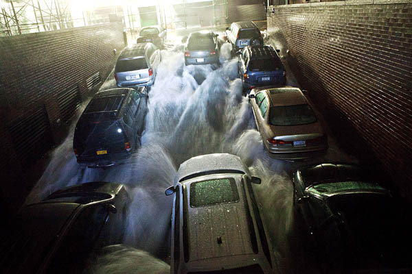 Rising water, caused by Hurricane Sandy, rushes into a subterranean parking garage in the financial district of New York City.