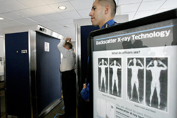 TSA agents operate a full-body scanner at San Diego's Lindbergh Field. 