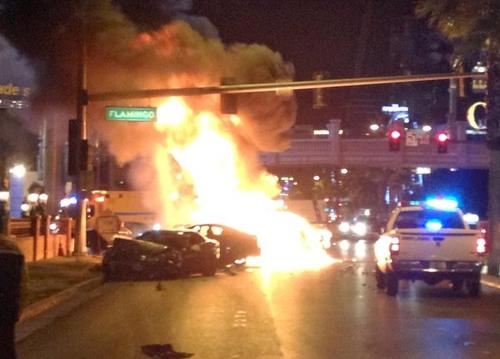Smoke and flames billow from a burning vehicle after a shooting and multicar accident on the Las Vegas Strip early Thursday.
