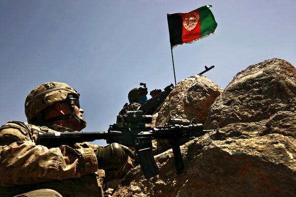 Military advisor Lt. Col. Gary King, left, of Florida watches an Afghan soldier at the top of Dragon's Back, where the Afghan army and police have been able to establish observation posts for the first time. Many Afghans in this area of Kandahar province seethed under the Taliban for eight years, and their sudden defiance has helped embolden Afghan security forces to fight back against the militant group.