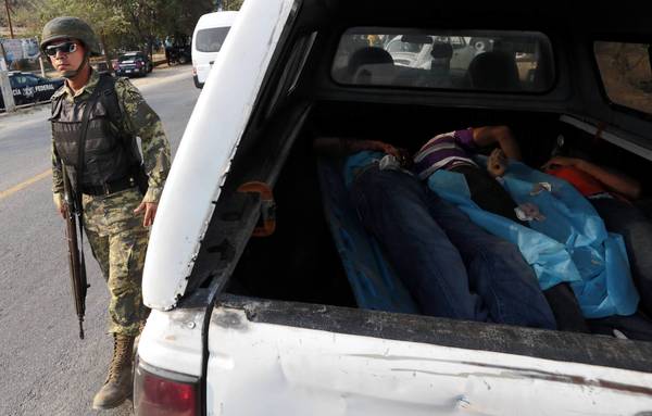 A van holds the corpses of four people killed in a shootout in Acapulco, Mexico.