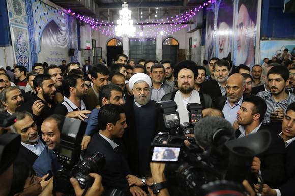 Iranian President-elect Hassan Rohani speaks to the media following a visit to the Khomeini mausoleum in Tehran