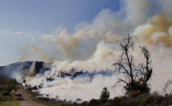 A wildfire burns along Sunrise Highway in Laguna Hills