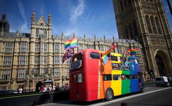 Supporters of same-sex marriage in Britain drive a campaign bus past the Houses of Parliament in London. (Andrew Cowie / AFP/ Getty Images / July 15, 2013)