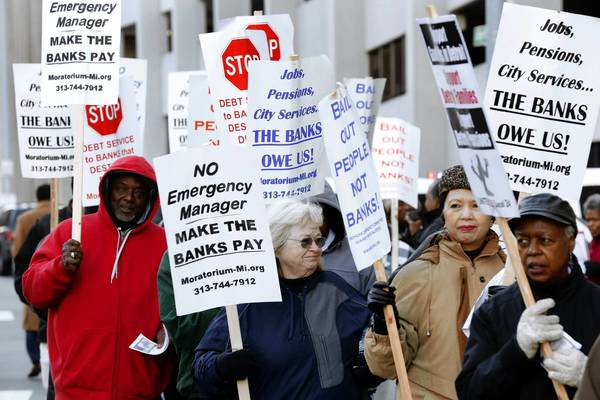 Protesters rally last month outside federal court in Detroit during a trial to determine whether the city is eligible to restructure $18 billion in debt. 