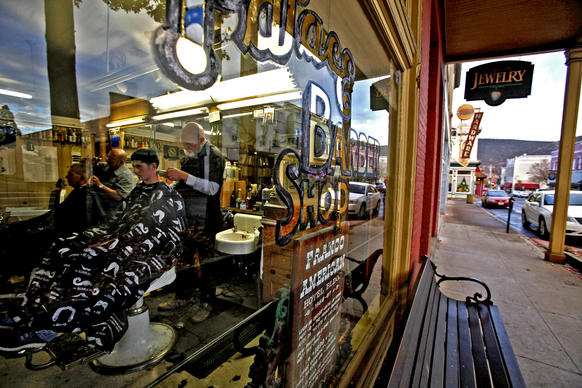 John Lisle, right, owner of the  Palace Barber Shop, cuts 14-year-old Isaiah Solus' hair in Yreka, Calif. "I think we should do it," said Isaiah about breaking away from California government.