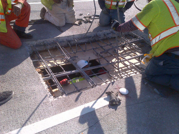 Crews fixing pothole