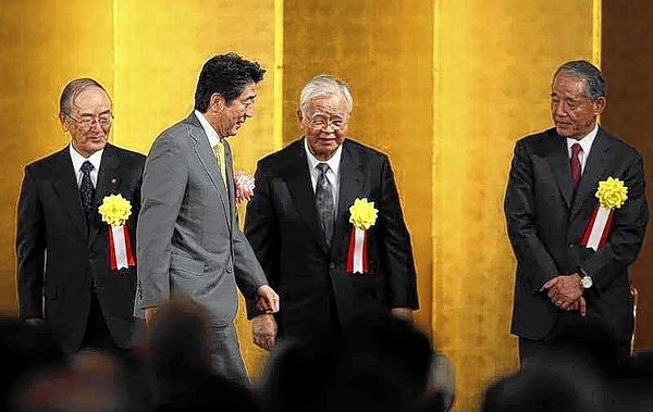 Japan's PM Abe walks past Japan Chamber of Commerce and Industry Chairman Mimura, Keidanren Chairman Yonekura and Japan Association of Corporate Executives Chairman Hasegawa after making a speech in Tokyo