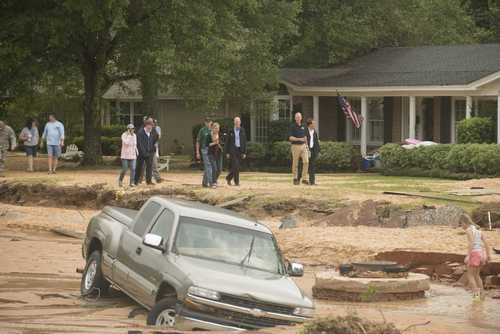 Florida Governor Rick Scott surveys flood damage to the Cordova Park neighborhood in Pensacola, Florida, on April 30, 2014.