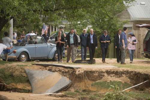 Florida Governor Rick Scott surveys flood damage to the Cordova Park neighborhood in Pensacola, Florida, on April 30, 2014.
