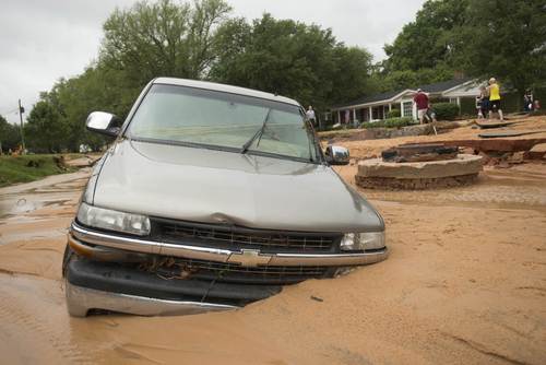 A vehicle is left partially submerged after flash flooding in the Cordova Park neighborhood in Pensacola, Florida, on April 30, 2014.