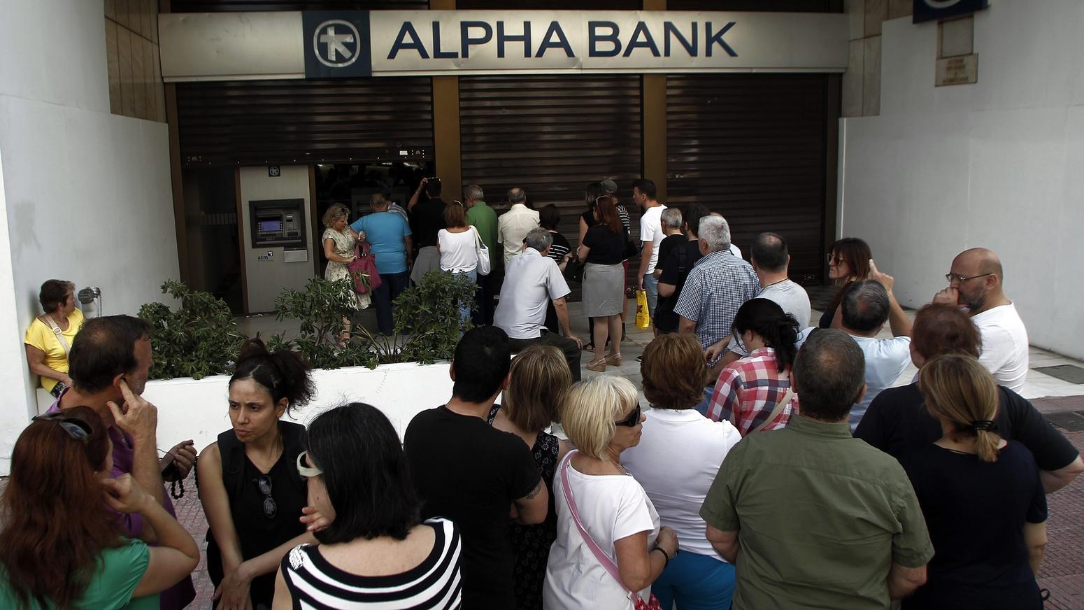 People withdraw money from ATM of Greek Alpha Bank