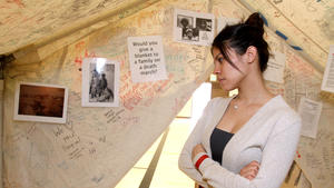 Glendale High School senior Kassandra Figueroa looks at information inside a genocide tent