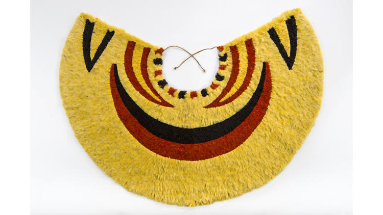 A cape made from yellow and black ‘ō‘ō feathers and red ‘i‘iwi feathers — part of a show of Hawaiian feathered garments at LACMA.