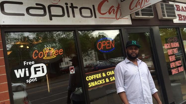 Burhan "Scot" Elmi stands outside his Capitol Cafe coffee shop.