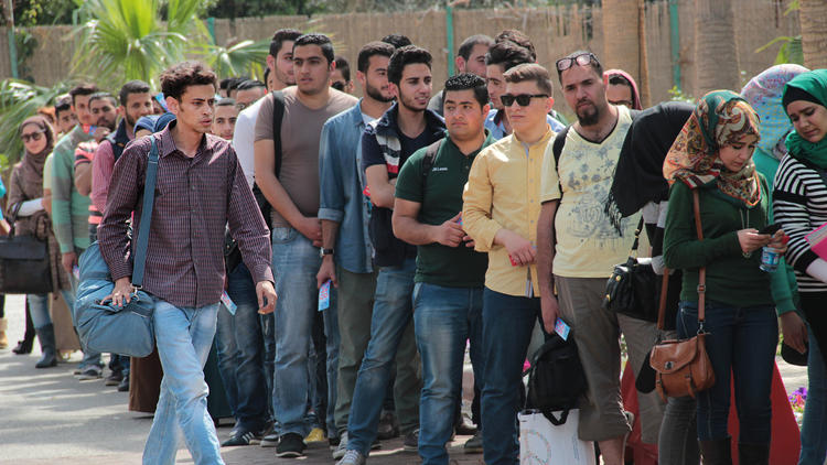 Mohammah Assaf (Tawfeek Barhom) walks to the head of the line of aspiring artists hoping to land a competition slot on "Arab Idol," in a scene from Hany Abu-Assad's "The Idol."