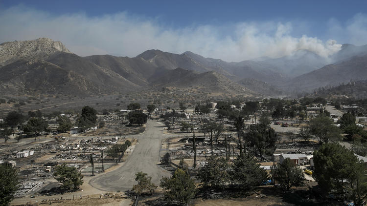 The wildfire still rages in the mountains after flames raced through a South Lake neighborhood.