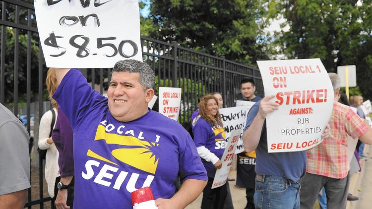 Luis Rodriguez leads picketers in front of Barrington High School Thursday. (Brian O'Mahoney/Pioneer Press)