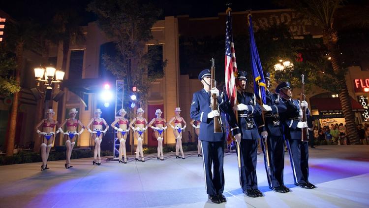 In an only-in-Vegas scene, soldiers and showgirls take to the stage together during an Independence Day celebration at the Linq Promenade.