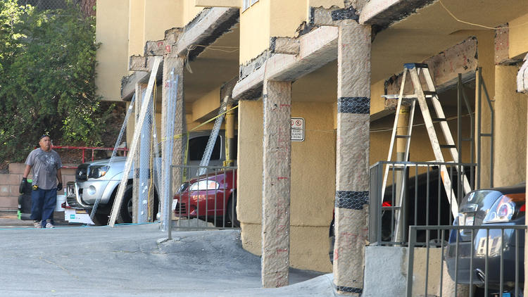 Construction workers seismically retrofit Montrose apartment building