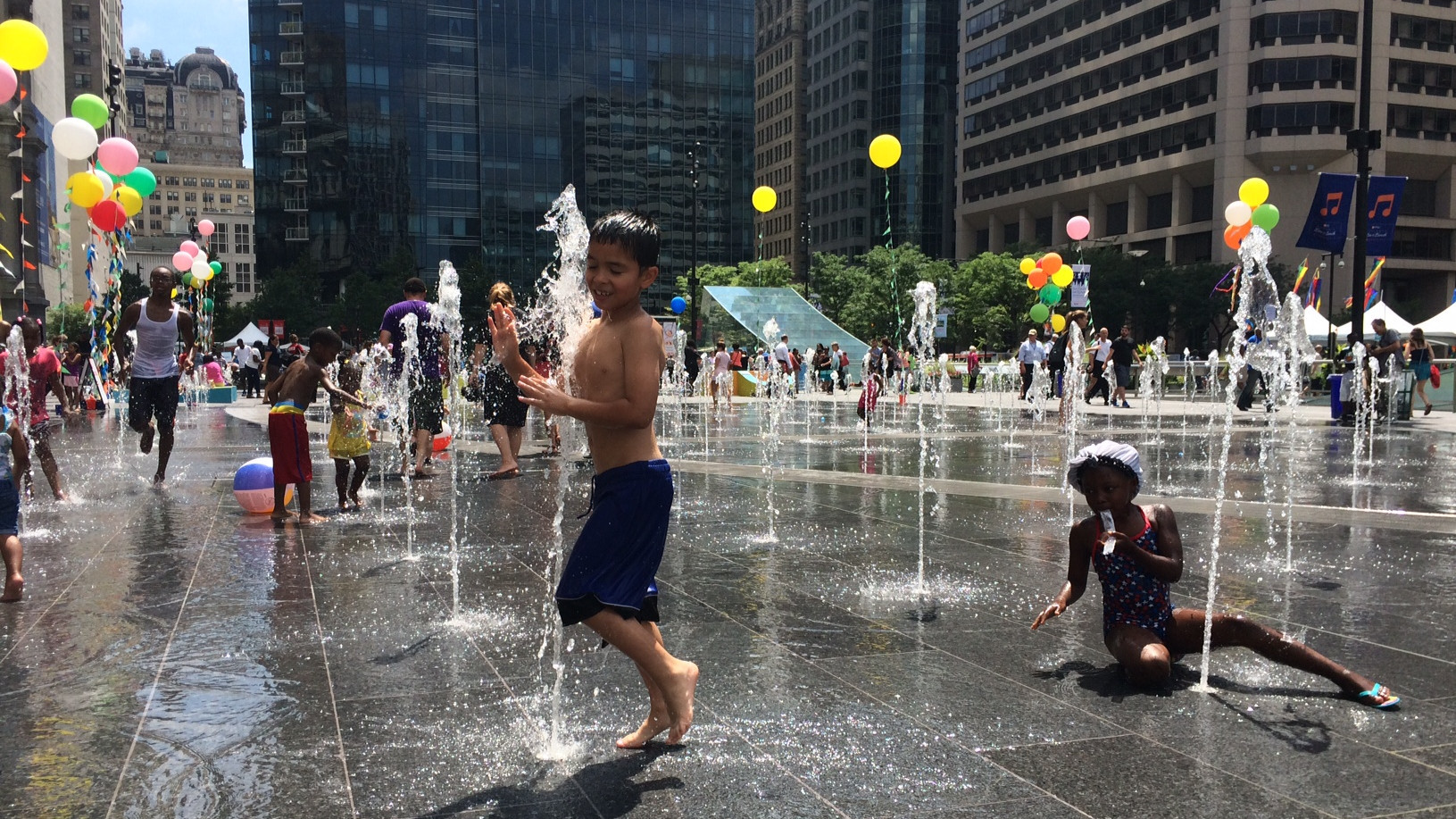 Children play in water fountains outside Philadelphia City Hall.