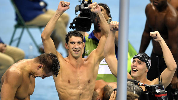 Michael Phelps, center, reacts along with teammates Nathan Adrian and Ryan Held after the U.S. won the gold in the 400-meter freestyle relay. (Martin Meissner / Associated Press)