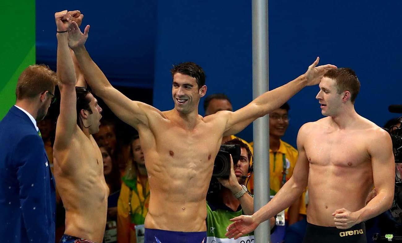 American swimmer Michael Phelps, center, celebrates with teammates after winning gold in the men's 400-meter medley relay on Saturday. (Robert Gauthier/Los Angeles Times)