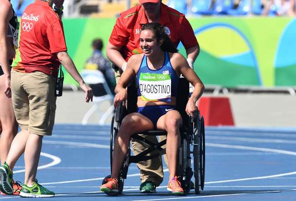 Abbey D'Agostino uses a wheelchair to get off the track Tuesday. (Jewel Samad / AFP/Getty Images)