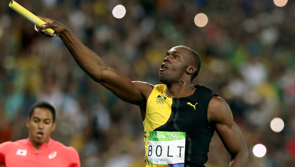 Usain Bolt celebrates after anchoring Jamaica's 400-meter relay team to a gold medal Friday. (Lee Jin-man / Associated Press)