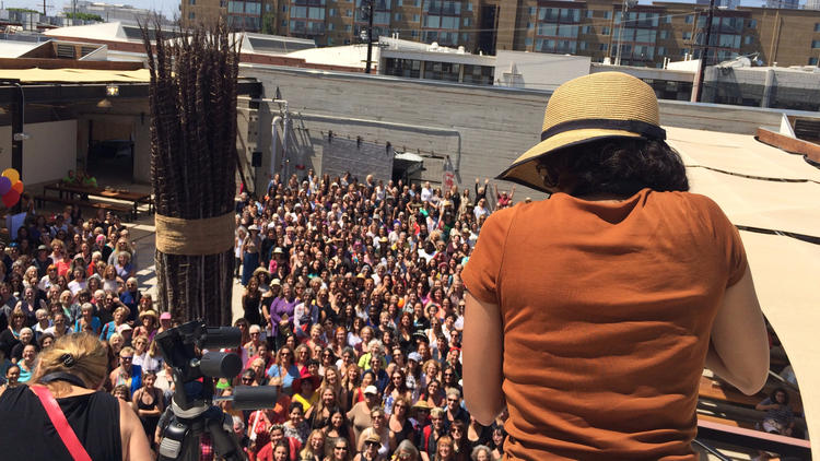 A photographer captures the crowd gathered inside the Hauser Wirth & Schimmel courtyard.