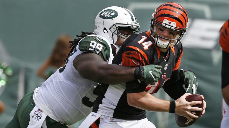 New York Jets defensive tackle Steve McLendon (99) sacks Cincinnati Bengals' Andy Dalton (14) during the first half of an NFL football game Sunday, Sept. 11, 2016 in East Rutherford, N.J. (AP Photo/Kathy Willens)