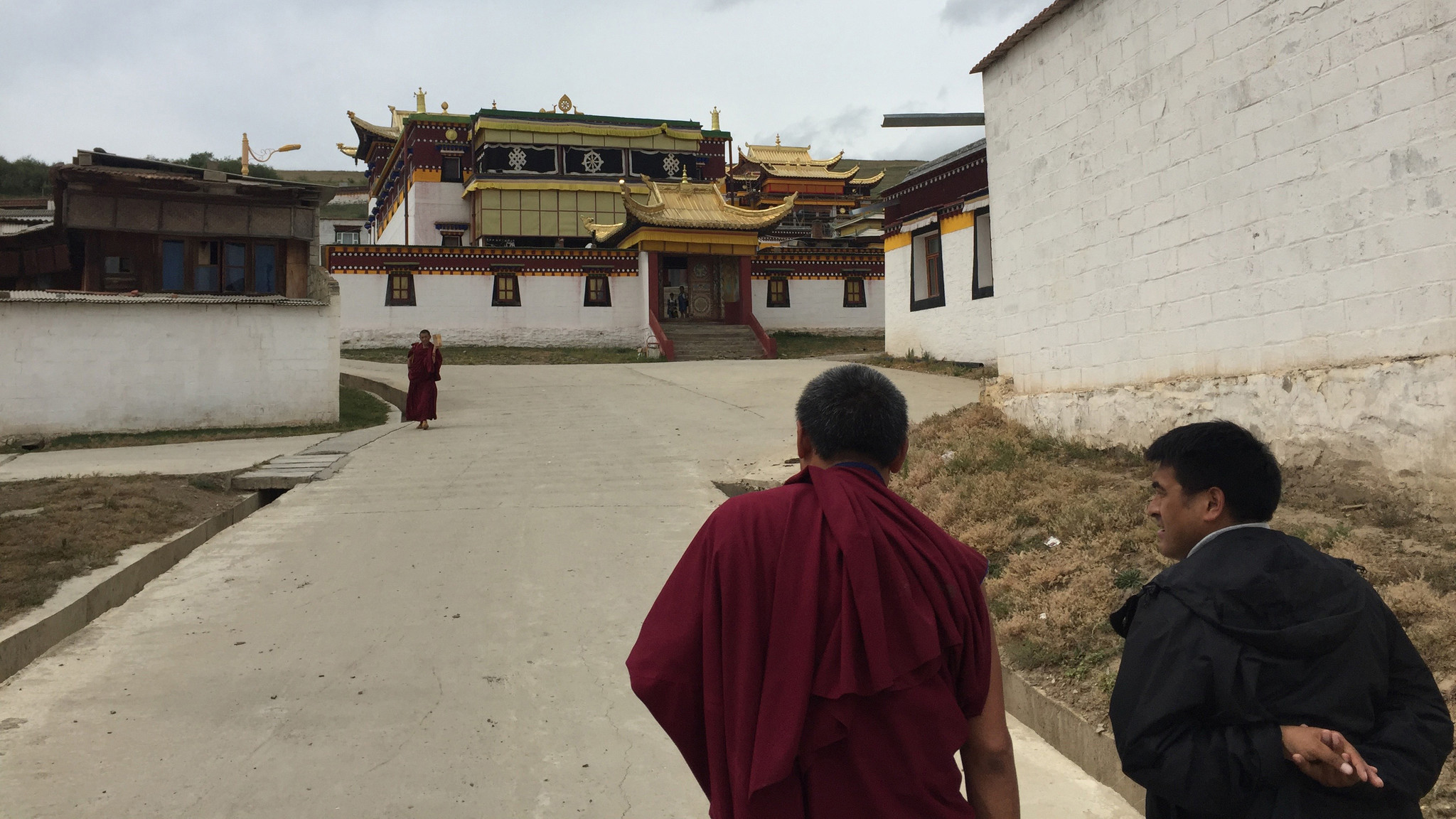 A monk and an official at the Dazha Monastery in Ruoergai County, Aba prefecture, chat as they walk toward a prayer room.