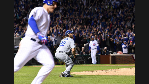 Dodgers pitcher Clayton Kershaw drops to the ground while giving up a home run to Cubs first baseman Anthony Rizzo in the fifth inning of Game 6. (Wally Skalij / Los Angeles Times)