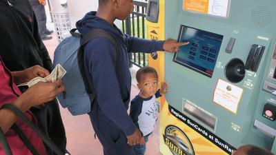 SunRail riders purchase tickets at the commuter train's Central Station.