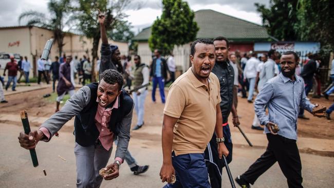 Somali migrants, fearing attack, march in the South African capital, Pretoria, on Feb. 24, 2017, armed with rocks and sticks.