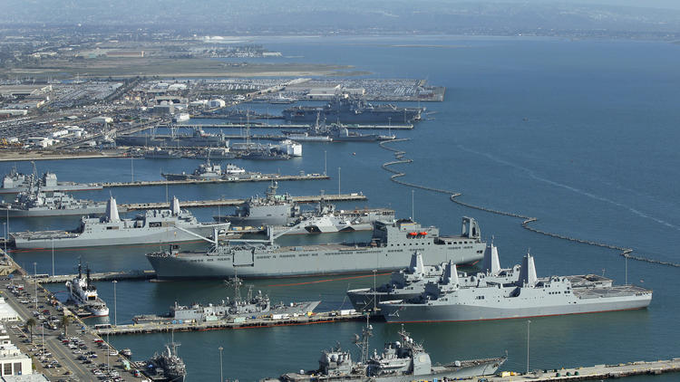 Warships are docked along San Diego Naval Base.