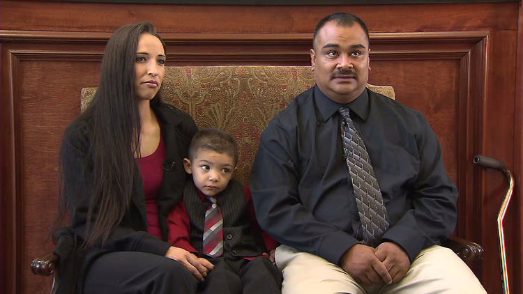 Jennifer Garcia Mendez, left, and Angel Mendez, right, sit with their son, A.J. Bendecito Mendez. The parents were shot in their Lancaster home by L.A. County sheriff's deputies on Oct. 1, 2010. (KTLA-TV Channel 5)