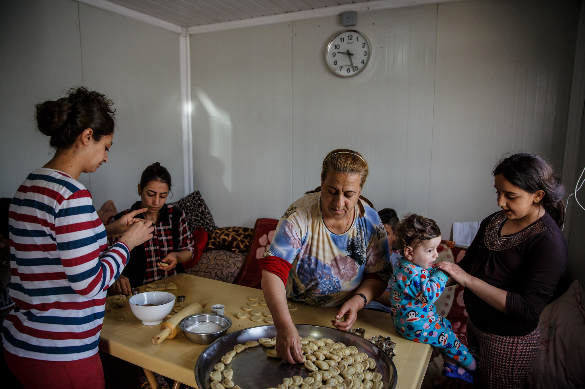 Suad Rahim makes klecha holiday cookies with her family at a Christian refugee camp in the Ainkawa neighborhood of Irbil on April 12.