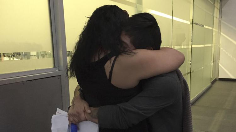Claudia Arias embraces her husband, Mauricio Marino, who was deported to Mexico.