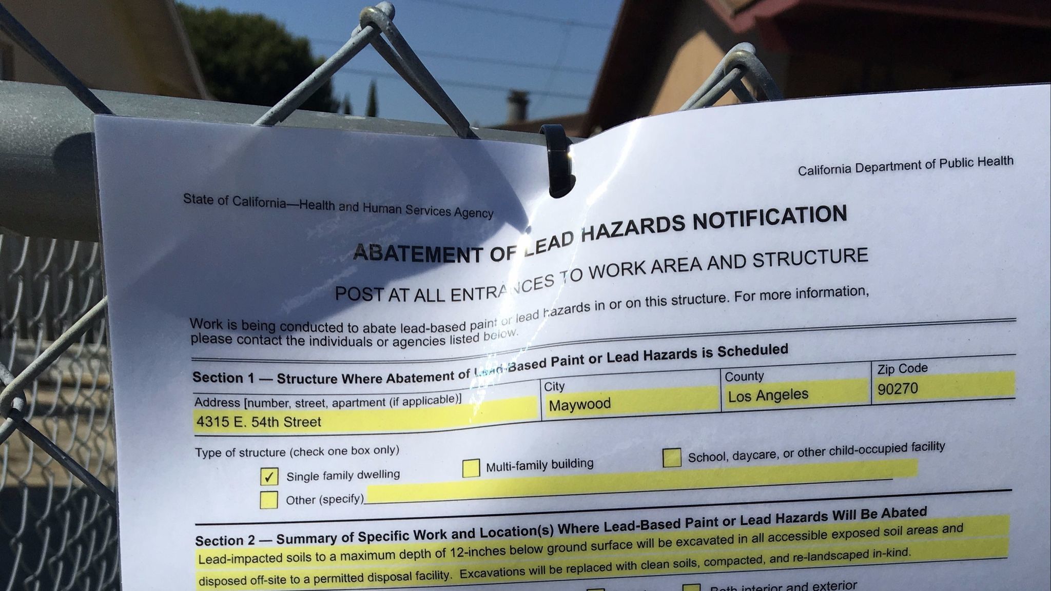 Lead hazard notifications, such as this one seen May 18 outside a home in Maywood, must be posted outside soil cleanup sites.