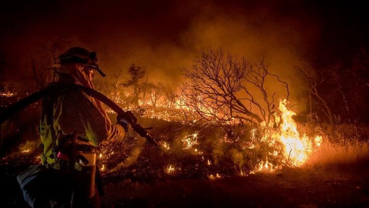 Firefighter Kern Kunst battles the Wall fire near Oroville, Calif.