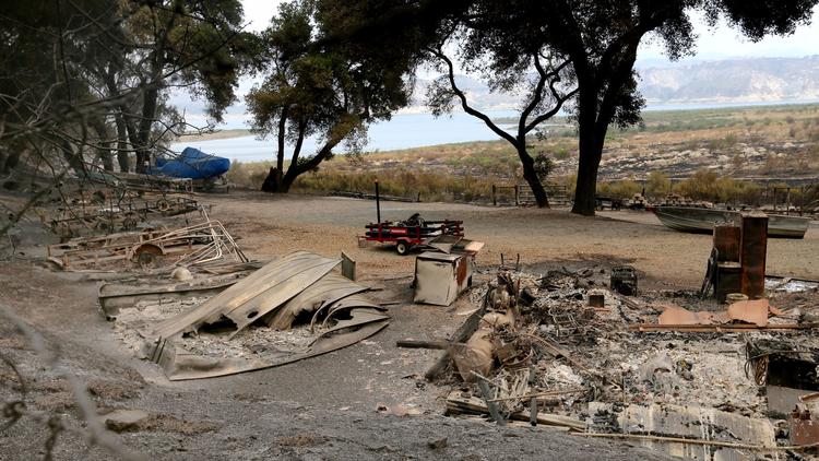 The remains of a structure and boats scorched by the Whittier fire in Los Padres National Forest nea