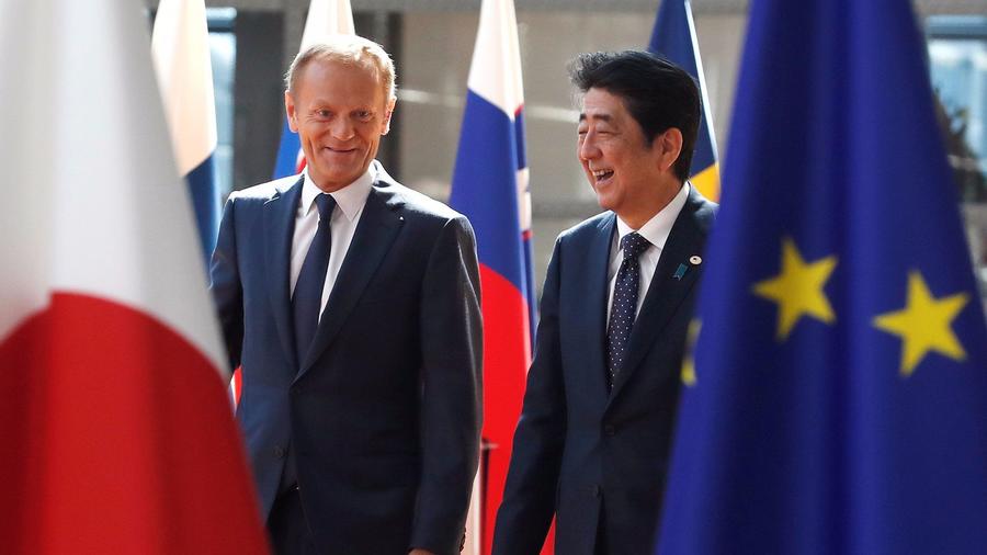 Japan's PM Abe is welcomed by EU Council President Tusk at the start of a EU-Japan summit in Brussels